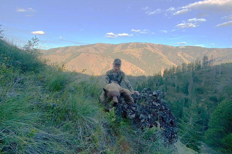 Hunter above a green spring canyon